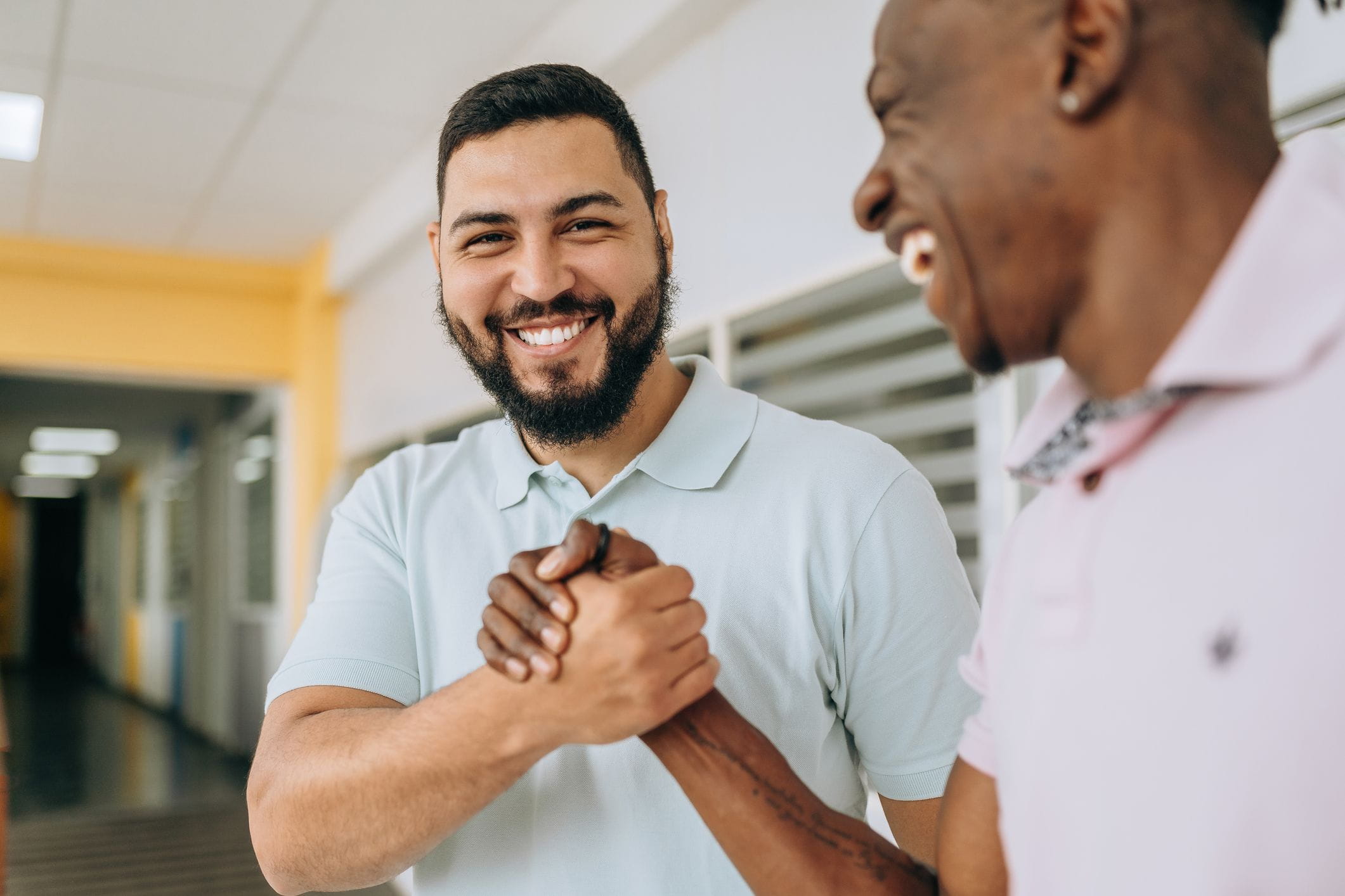 two happy men shaking hands