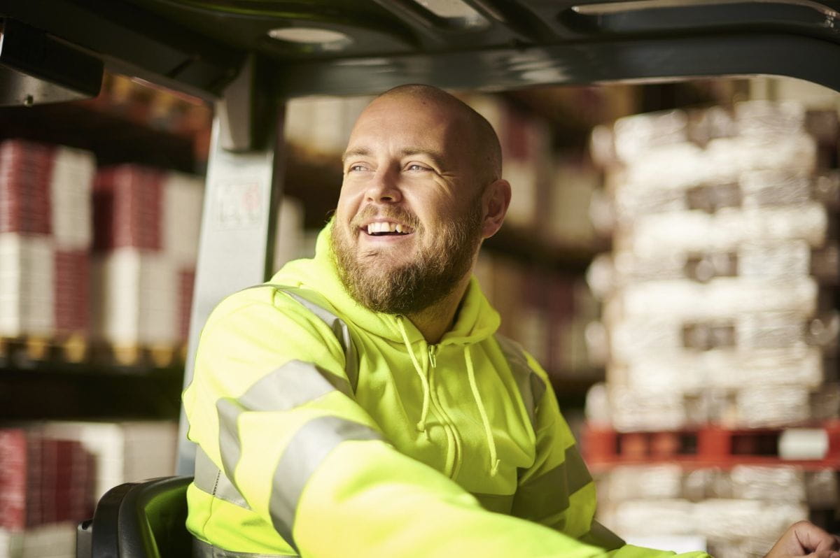 warehouse employee smiling at work
