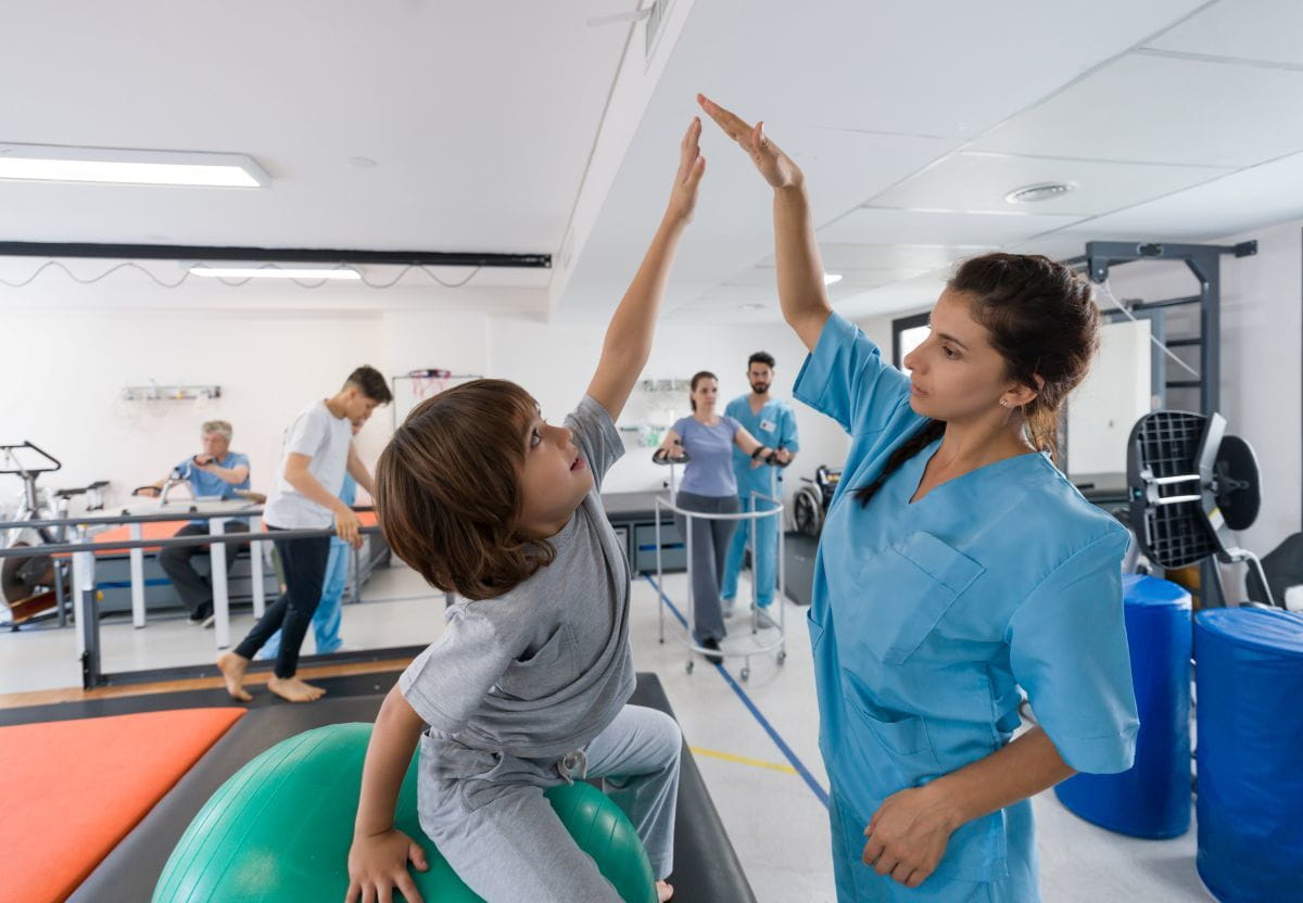 physical therapist working with young child
