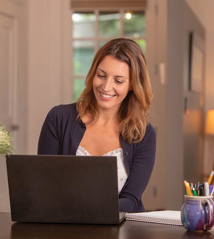 Woman using her laptop to contact Bright Horizons