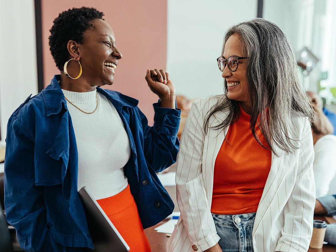 Two women looking at each other smiling