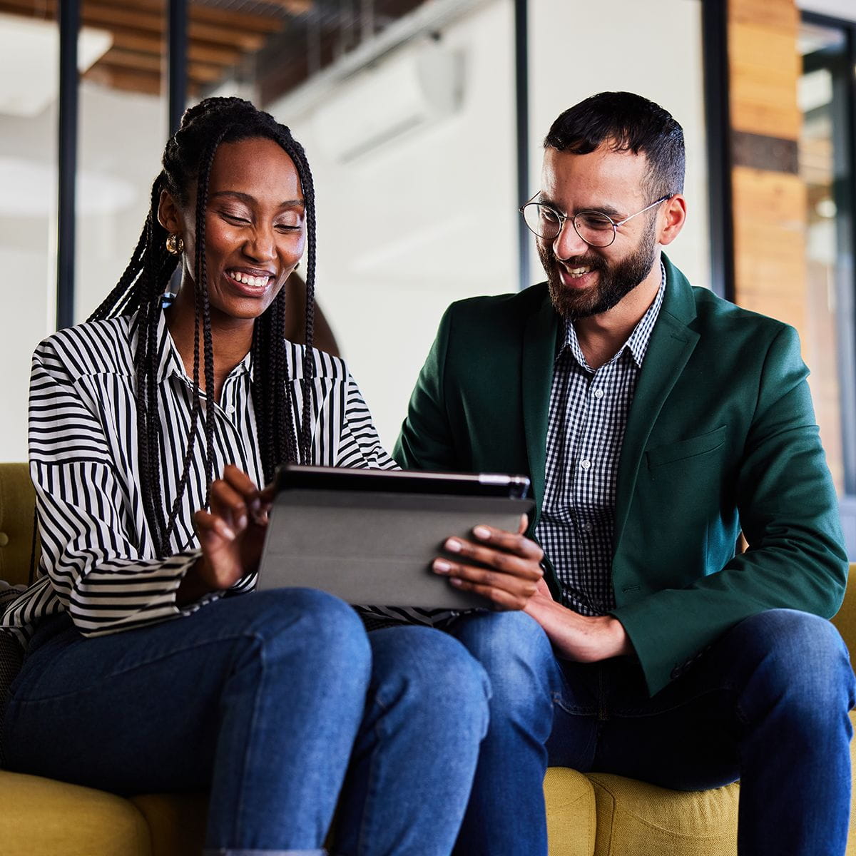 Two professionals looking at a tablet