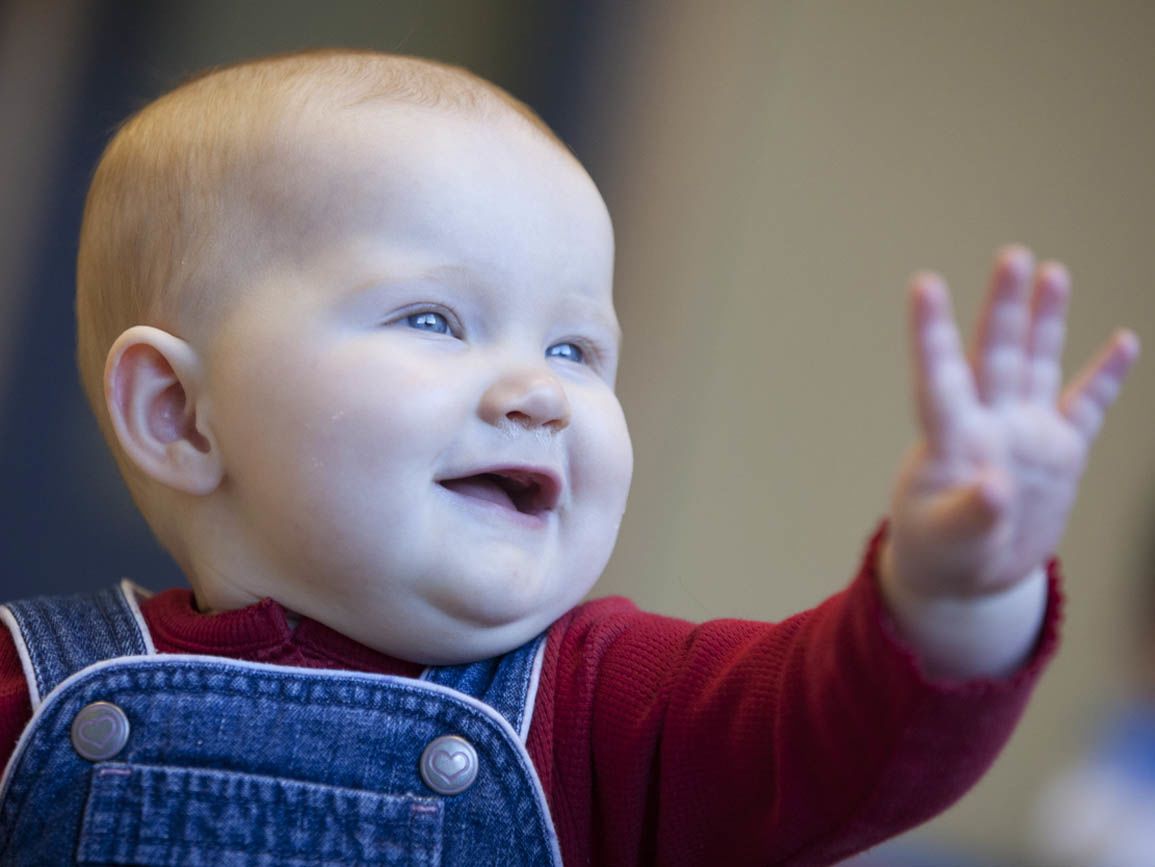 A maybe making a sign with his hand
