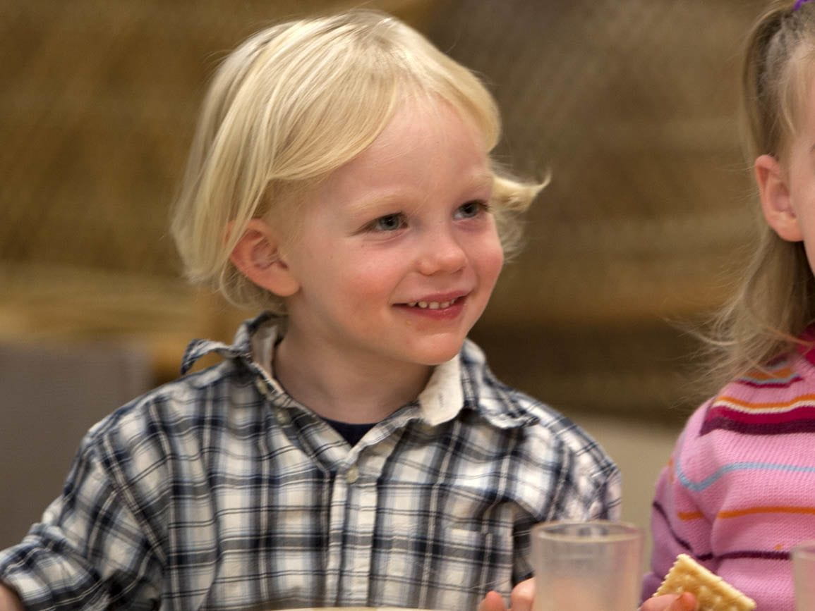 Boy Eating with Family