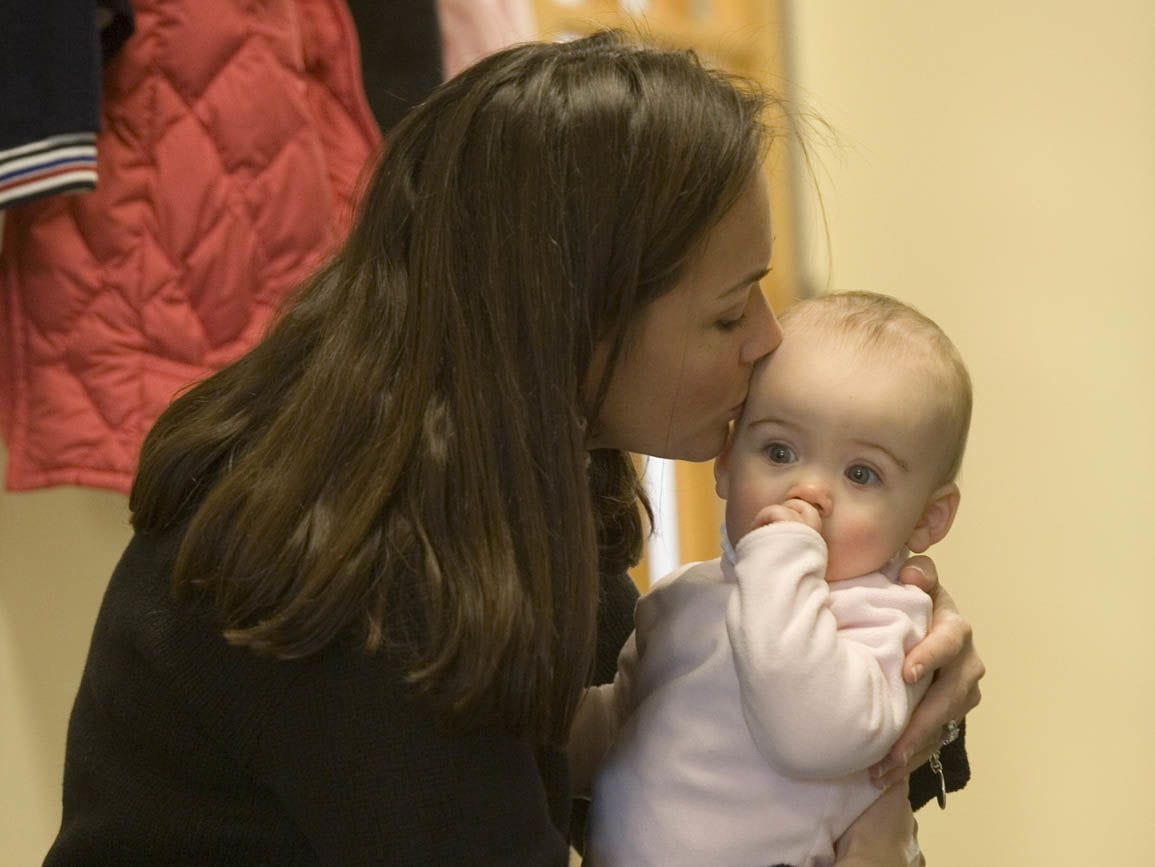 Mom kissing baby girl
