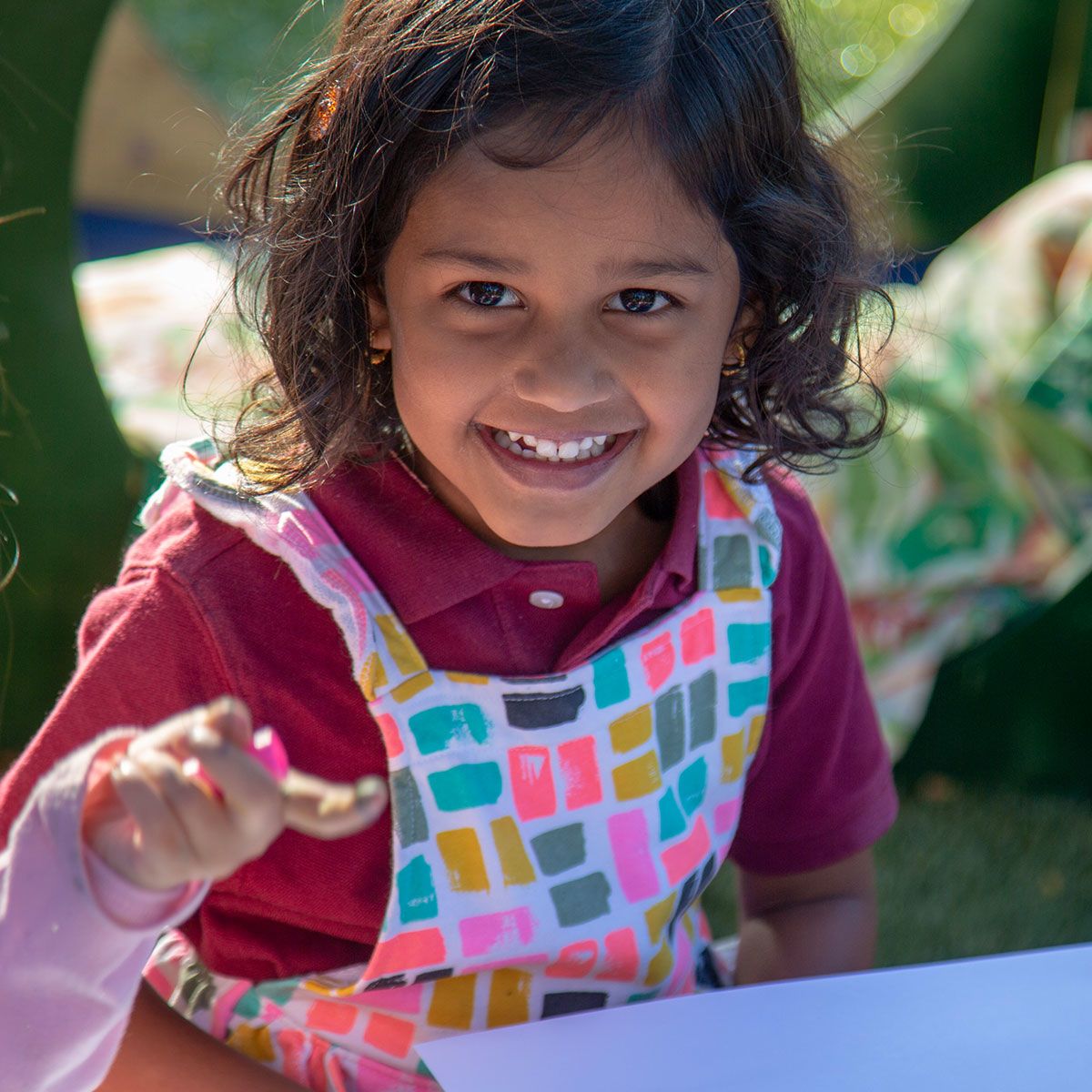 Kindergarten prep girl sitting outside smiling