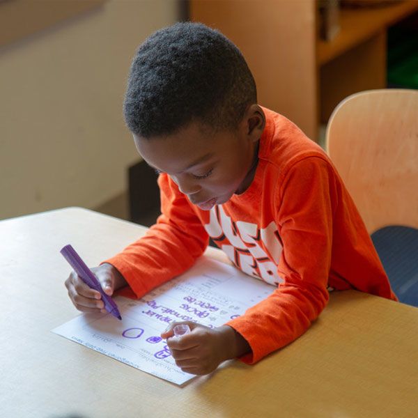 boy drawing on paper