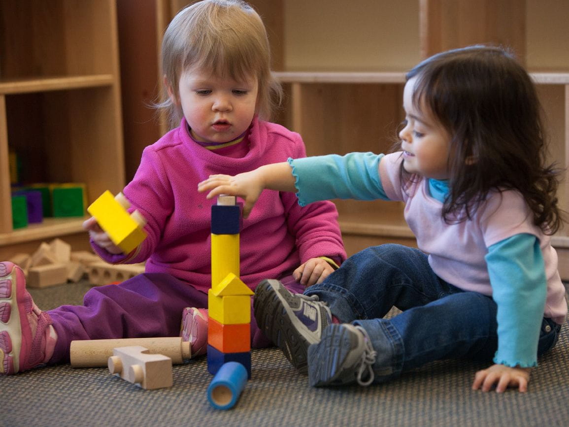 Two children playing with blocks