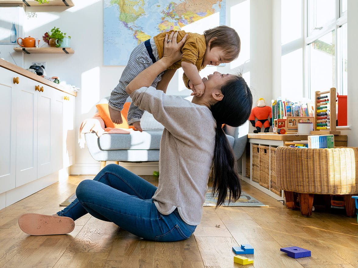 mother lifting child in air