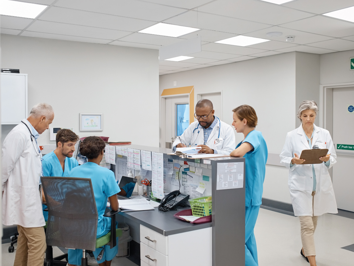 Nurses station with a group of healthcare workers collaborating