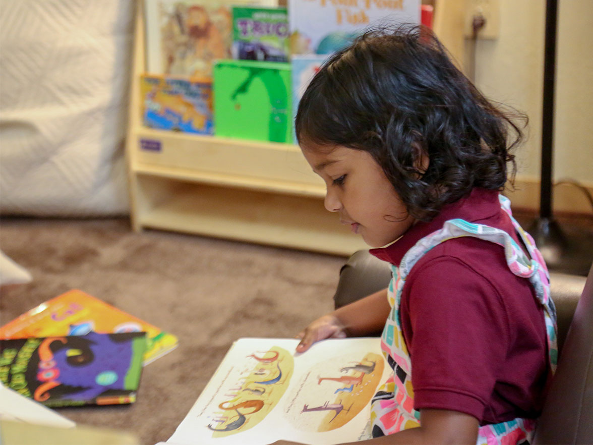 Hispanic girl reading a book