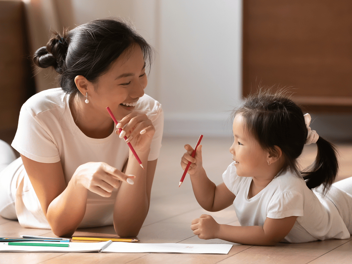 Mother and daughter draw together at home