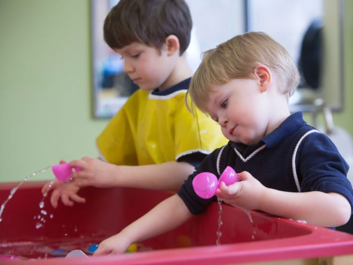 Two boys playing with water