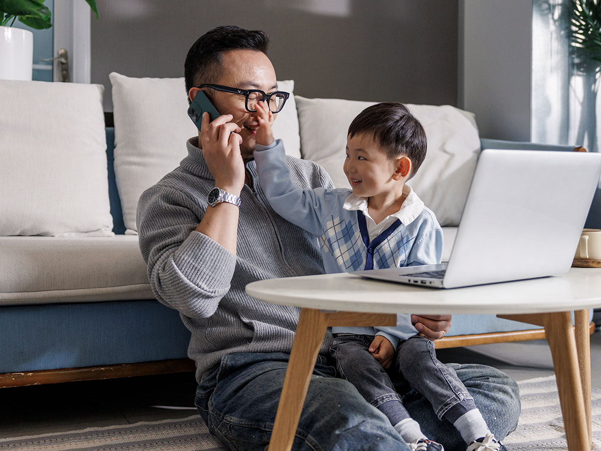 Working parent talking on phone with child