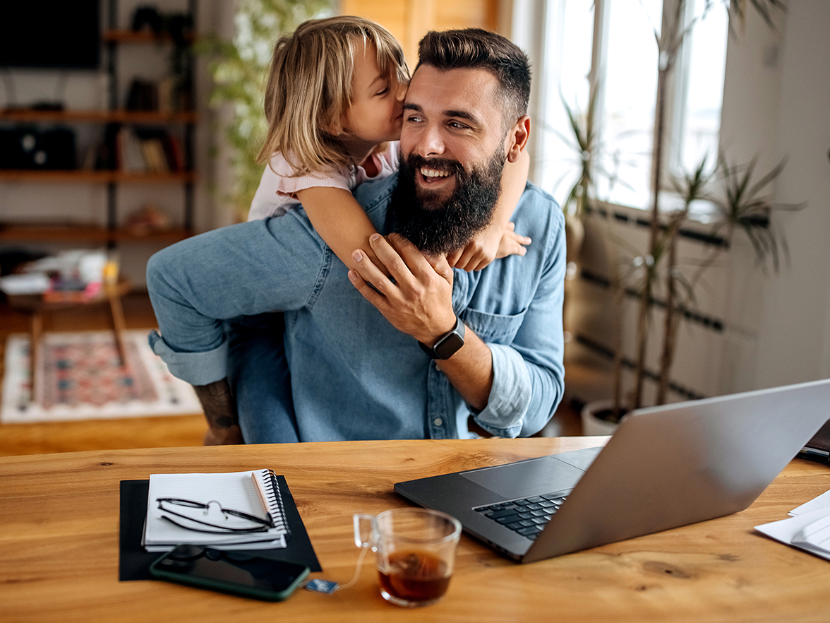 Dad with daughter working from home