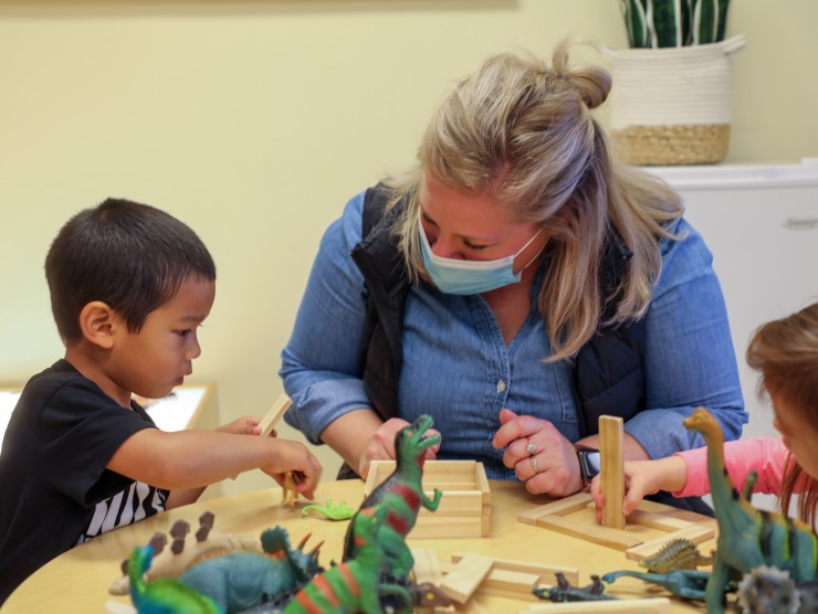 teacher sitting with child 