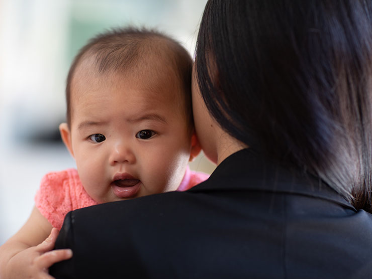 Woman in suit with infant