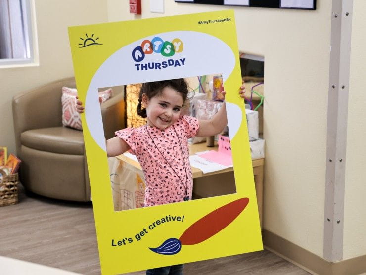 child holding photo frame 