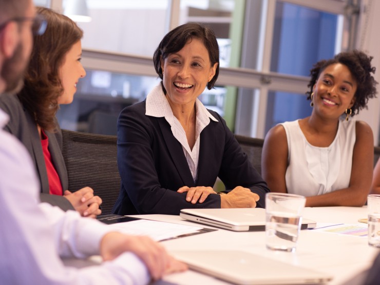 co-workers sitting around table 