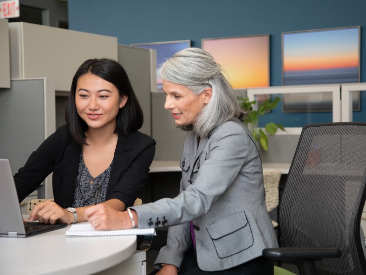 co-workers sitting at desk 