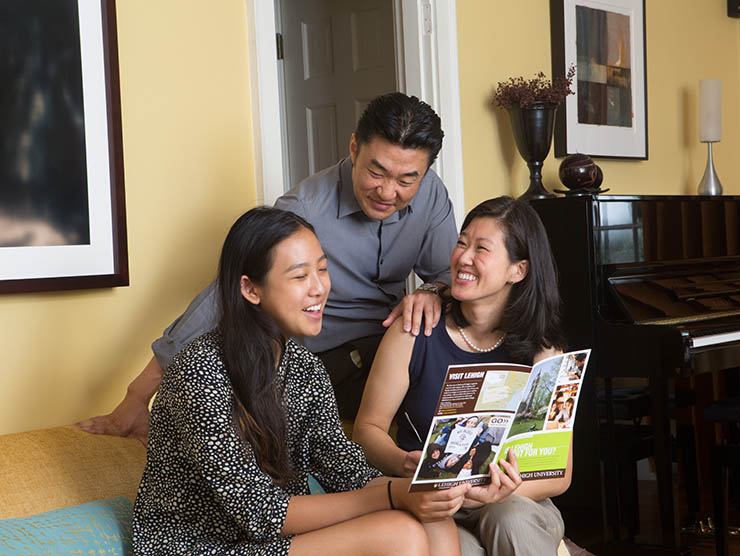 Family looking at college brochure