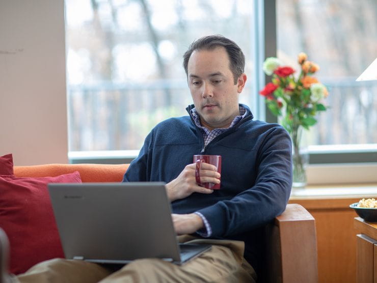 man sitting with laptop 