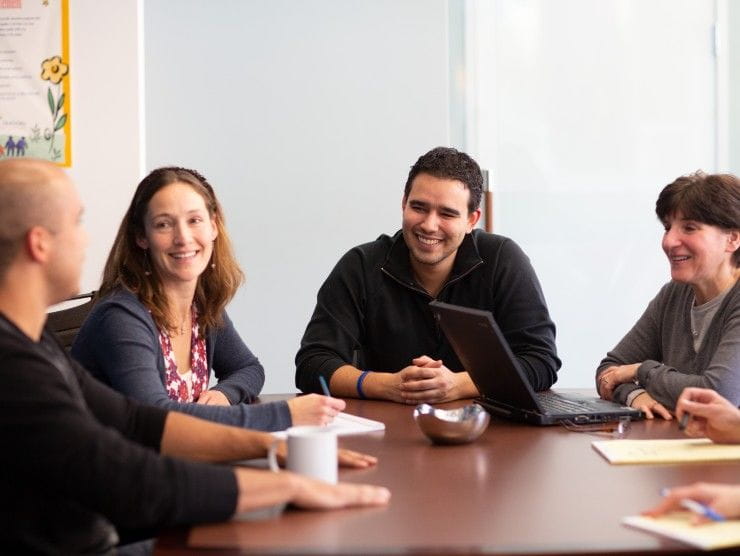 co-workers sitting around table 