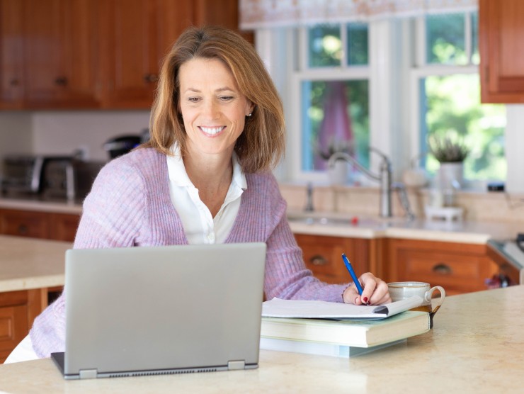 woman sitting at counter with laptop