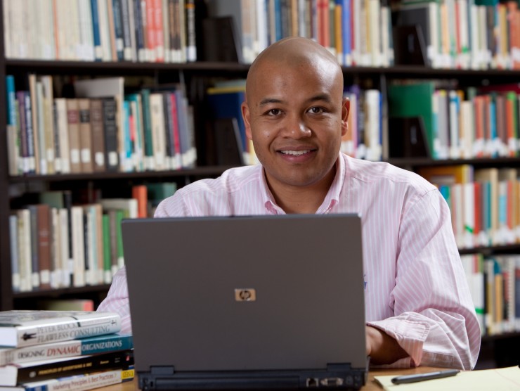 man at table with laptop