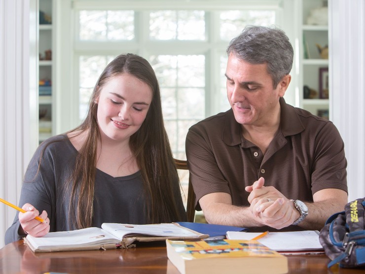 father and daughter sitting at counter