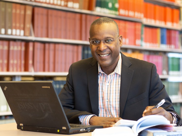 man at table with books