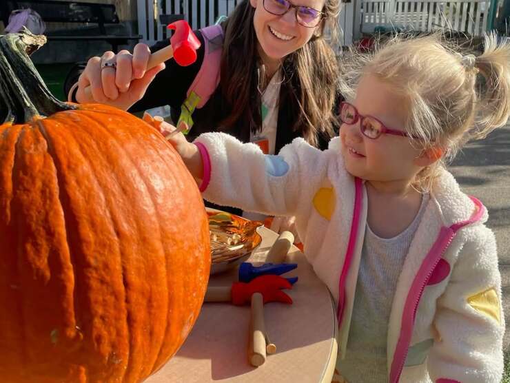 child with pumpkin