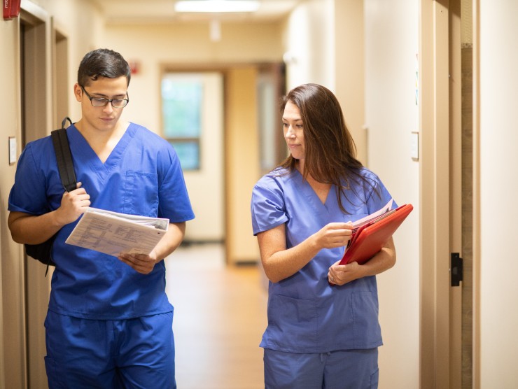 healthcare workers walking down hallway 