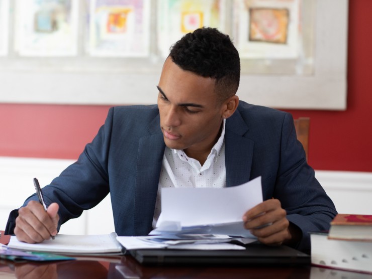 man sitting at table with notebook 