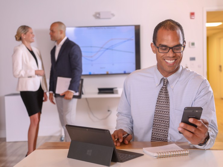 man sitting at table with laptop 