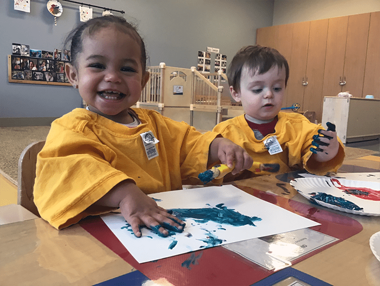 Two children finger painting