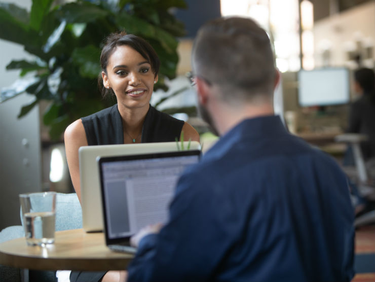 Female employee talking to male co-worker