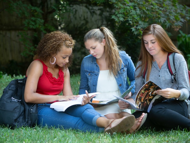 students sitting reading books 