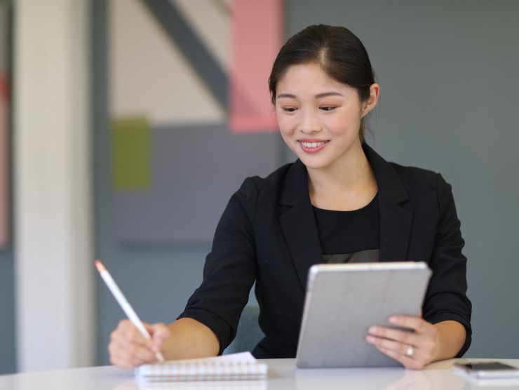 women sitting at table with notebook 