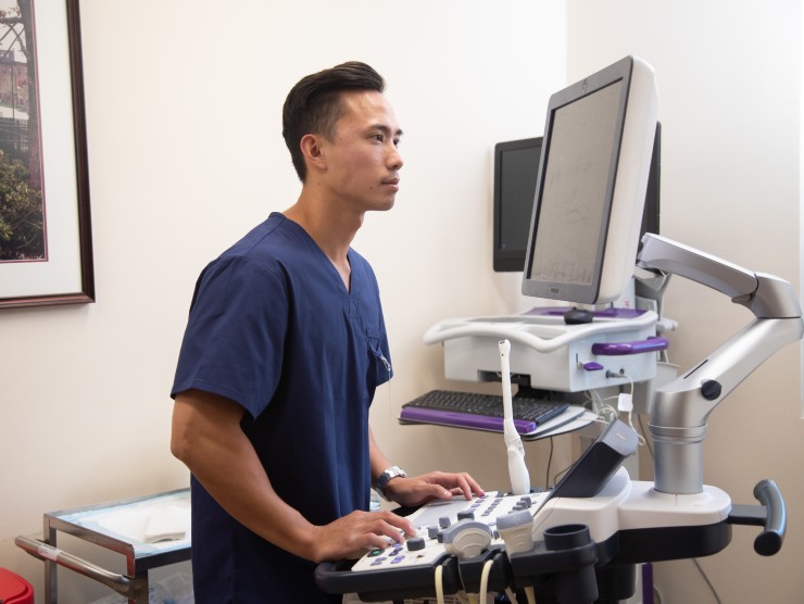 nurse standing looking at computer 