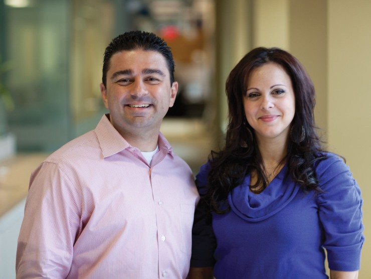 two co-workers smiling 