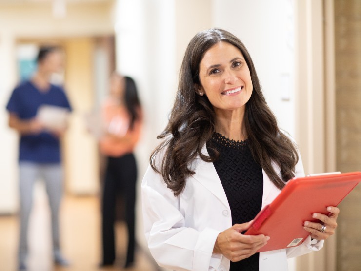 doctor standing with clip board 