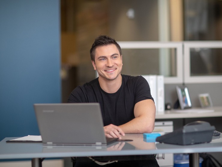 employee sitting with laptop 