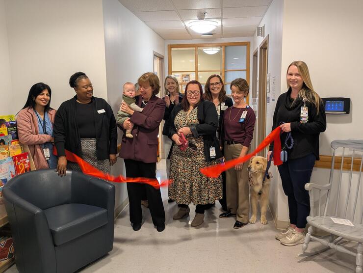 group of people cutting ribbon 