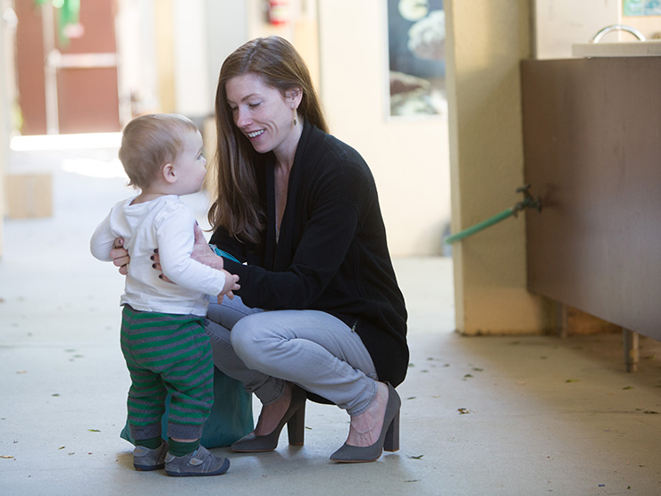 Mom picking up child