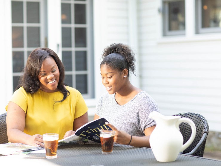 mother and daughter sitting at table 