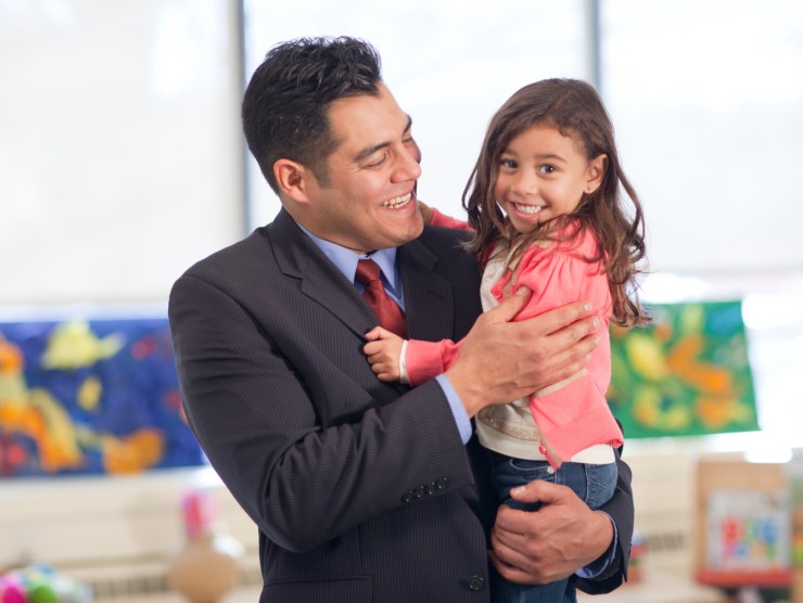 dad holding daughter in center 