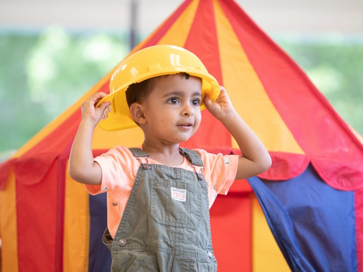 child playing with hat 