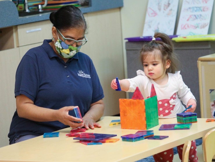 child care worker with child 