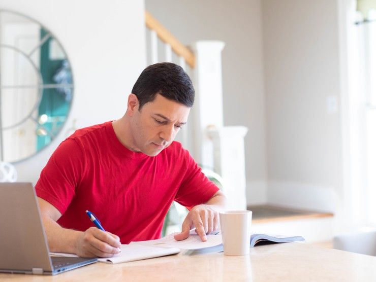 man sitting at counter studying 